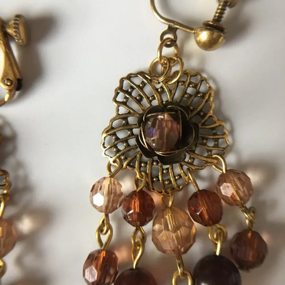 Darling ornate clip on earrings with beaded accents in amber/garnet tones